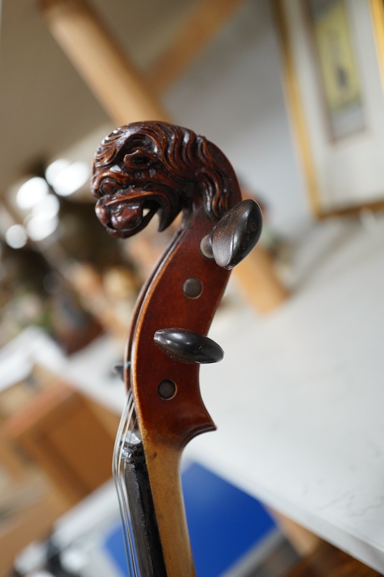 A cased late 19th century German Mittenwald violin with lion’s head scroll, and two bows, Ivory submission ref: RP2E5HT1